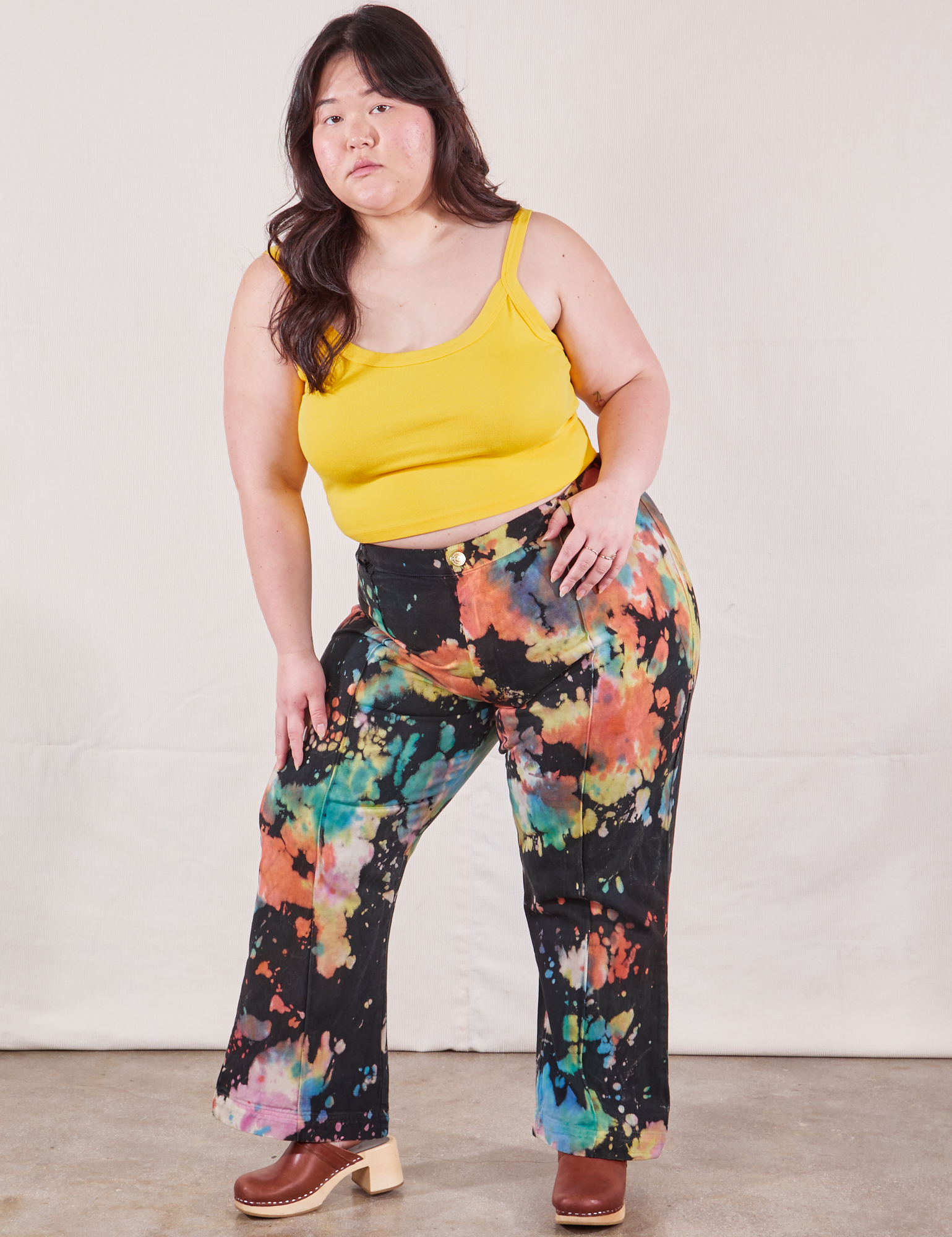 Ashley is 5'7" and wearing 1XL Western Pants in Rainbow Magic Waters paired with sunshine yellow Cami