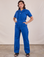 Tiara is 5'4" and wearing S Short Sleeve Jumpsuit in Royal Blue