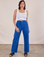 Tiara is 5'4" and wearing S Work Pants in Royal Blue paired with a Cropped Tank in vintage tee off-white