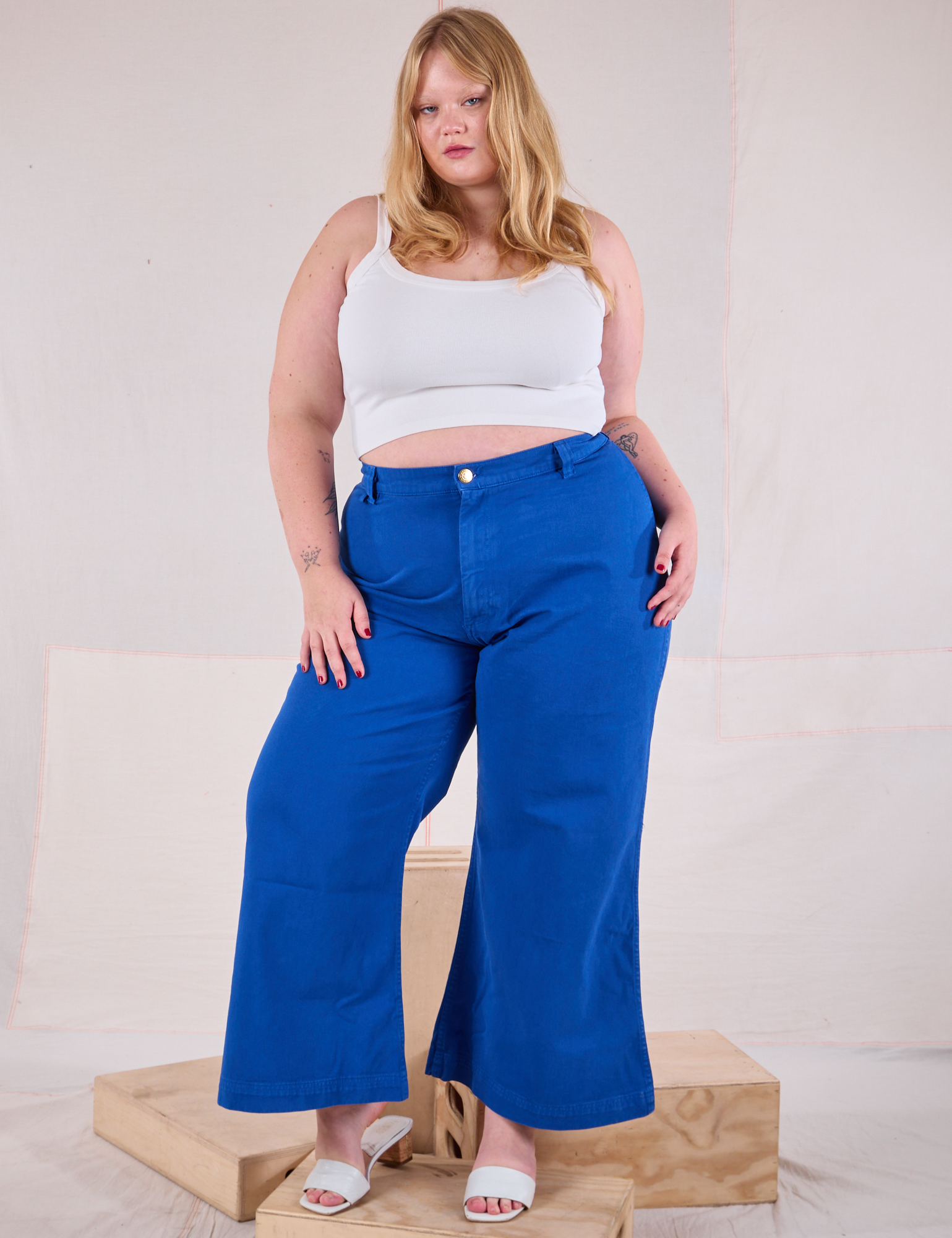 Juliet is 5'7" and wearing 1XL Bell Bottoms in Royal Blue paired with a Cami in Vintage Tee Off-White