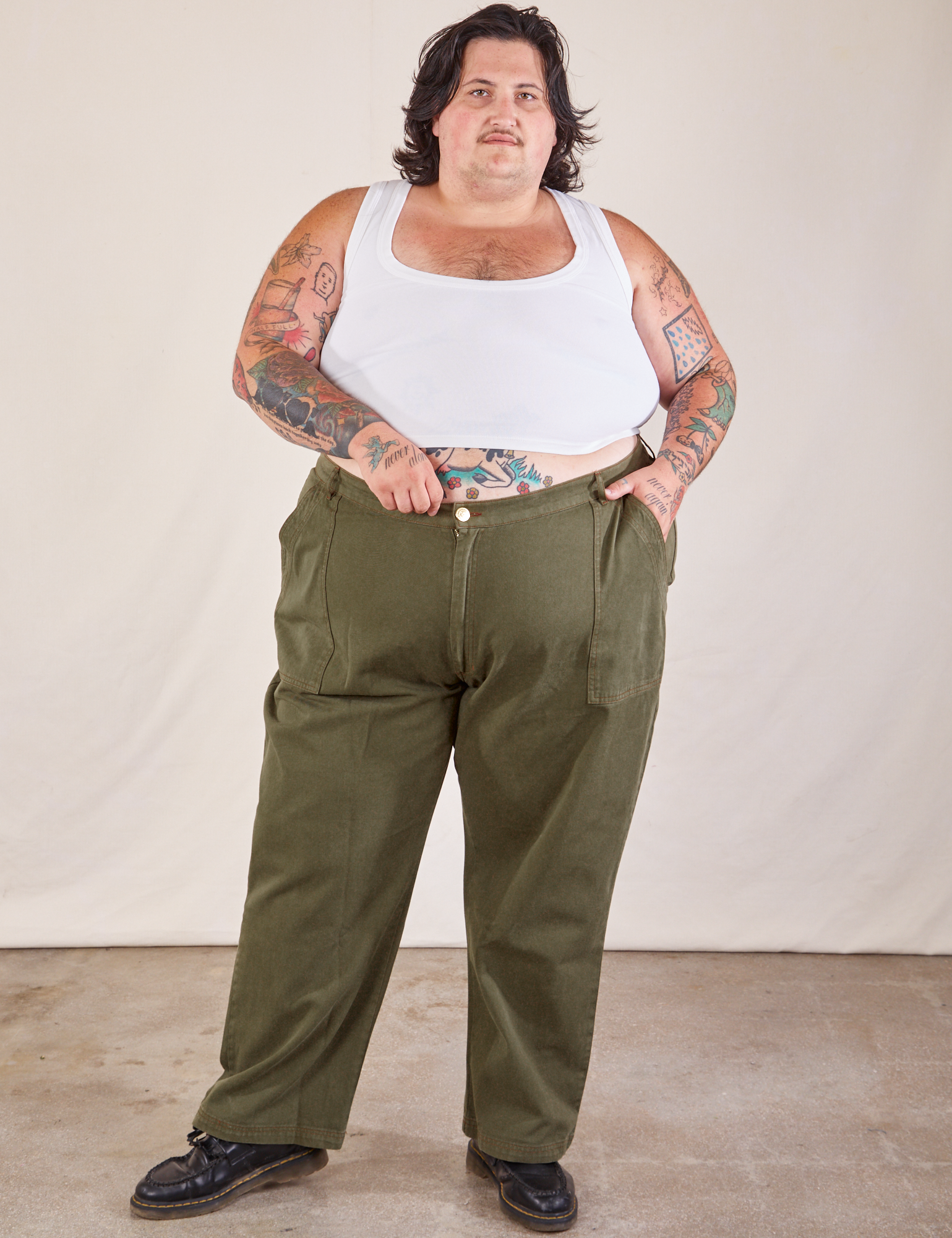 Sam is 5'10 and wearing 4XL Work Pants in Surplus Green paired with a Cropped Tank in vintage tee off-white