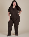 Ashley is 5'7" and wearing 1XL Short Sleeve Jumpsuit in Espresso Brown
