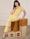 Alex is wearing Short Sleeve Jumpsuit in Butter Yellow