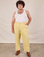 Miguel is 6'0" and wearing 2XL Work Pants in Butter Yellow paired with a Tank Top in vintage tee off-white