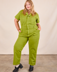 Juliet is 5'7" and wearing 1XL Short Sleeve Jumpsuit in Gross Green