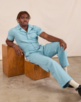 Issac is wearing Short Sleeve Jumpsuit in Baby Blue