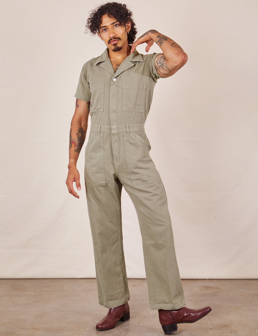Jesse is 5'7" and wearing S Short Sleeve Jumpsuit in Khaki Grey