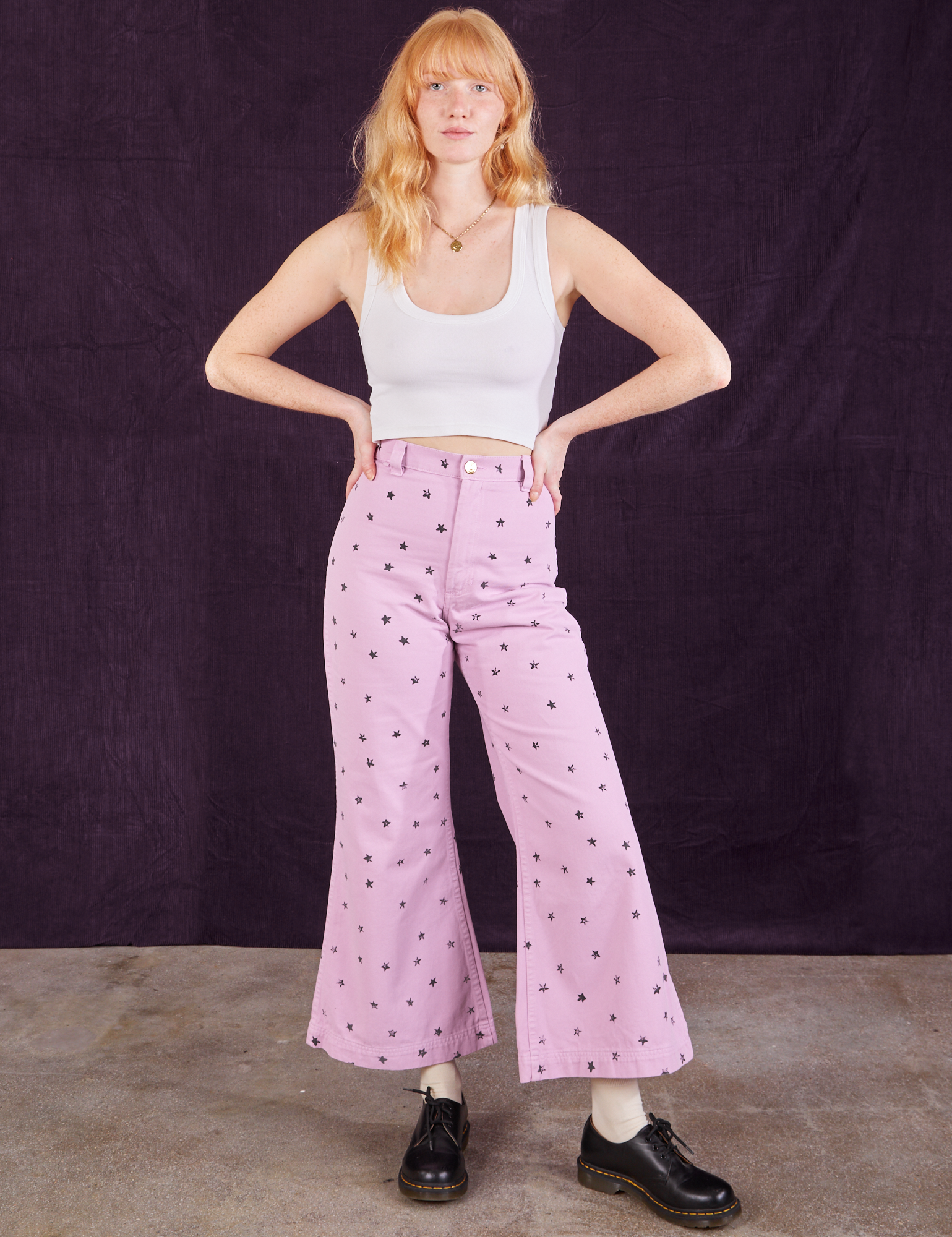 Margaret is 5&#39;11&quot; and wearing XXS Star Bell Bottoms in Lilac Purple paired with a Cropped Tank in vintage tee off-white