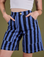 Front close up of Longline Work Shorts in Cornflower on Alex with both hands in the pockets