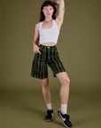 Alex is 5’8” and wearing XXS Longline Work Shorts in Evergreen paired with vintage tee white Cropped Tank
