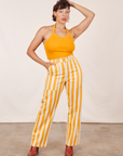 Tiara is 5'4" and wearing S Work Pants in Lemon Stripe paired with mustard yellow Halter Top