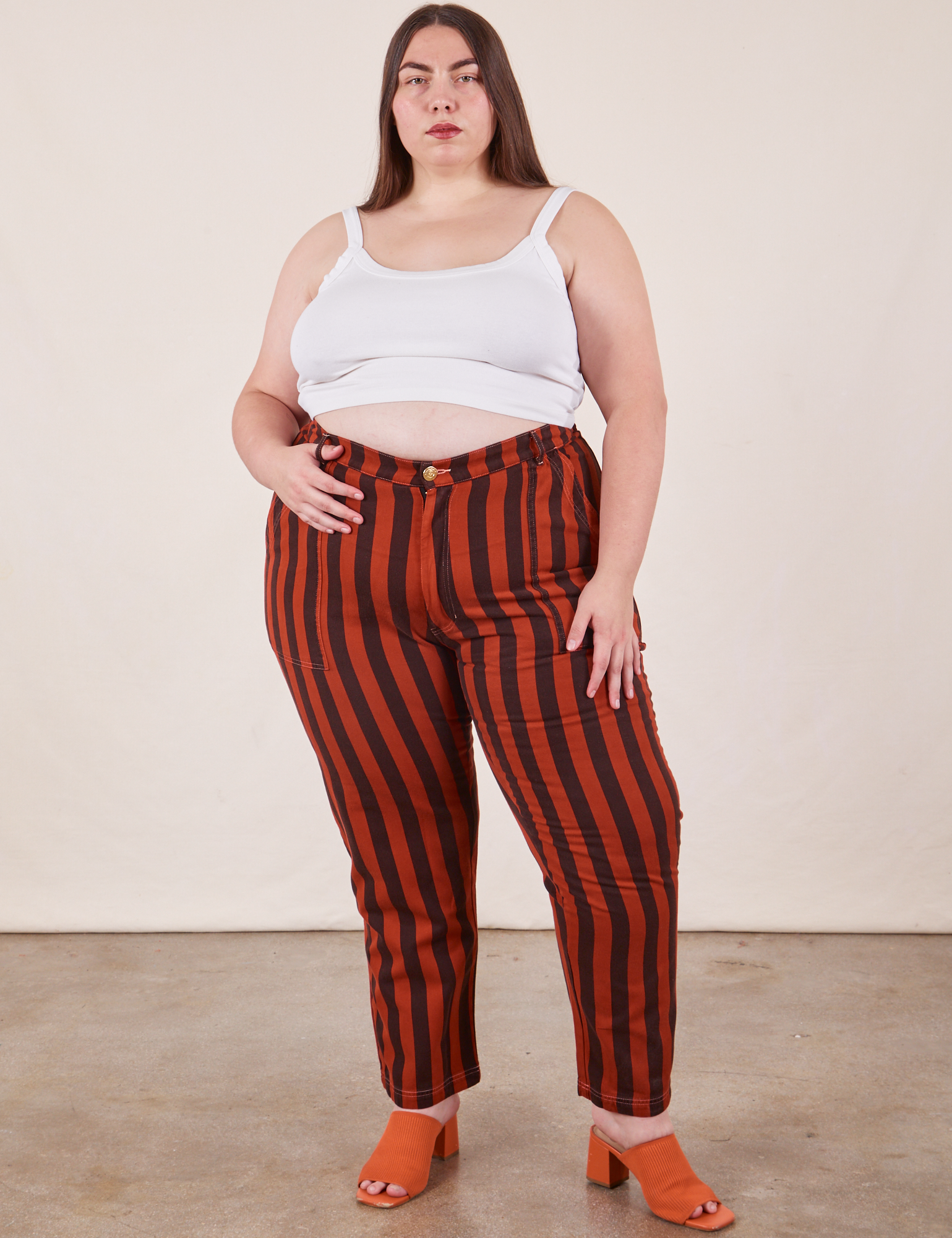 Marielena is 5&#39;8&quot; and wearing 2XL Black Striped Work Pants in Paprika paired with vintage off-white Cropped Cami