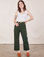 Hana is 5'3" and wearing XXS Petite Work Pants in Swamp Green paired with Cropped Tank Top in vintage tee off-white