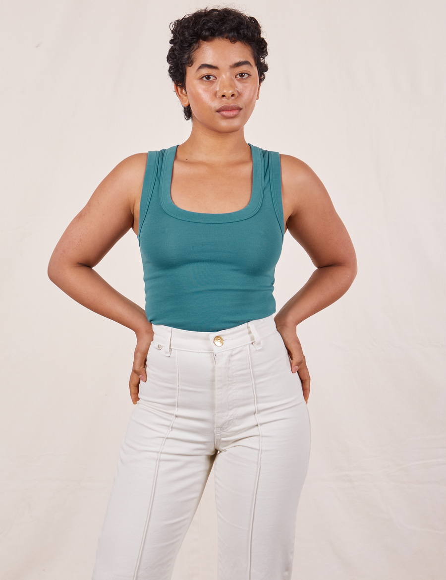 Mika is wearing size P Tank Top in Marine Blue paired with vintage off-white Western Pants