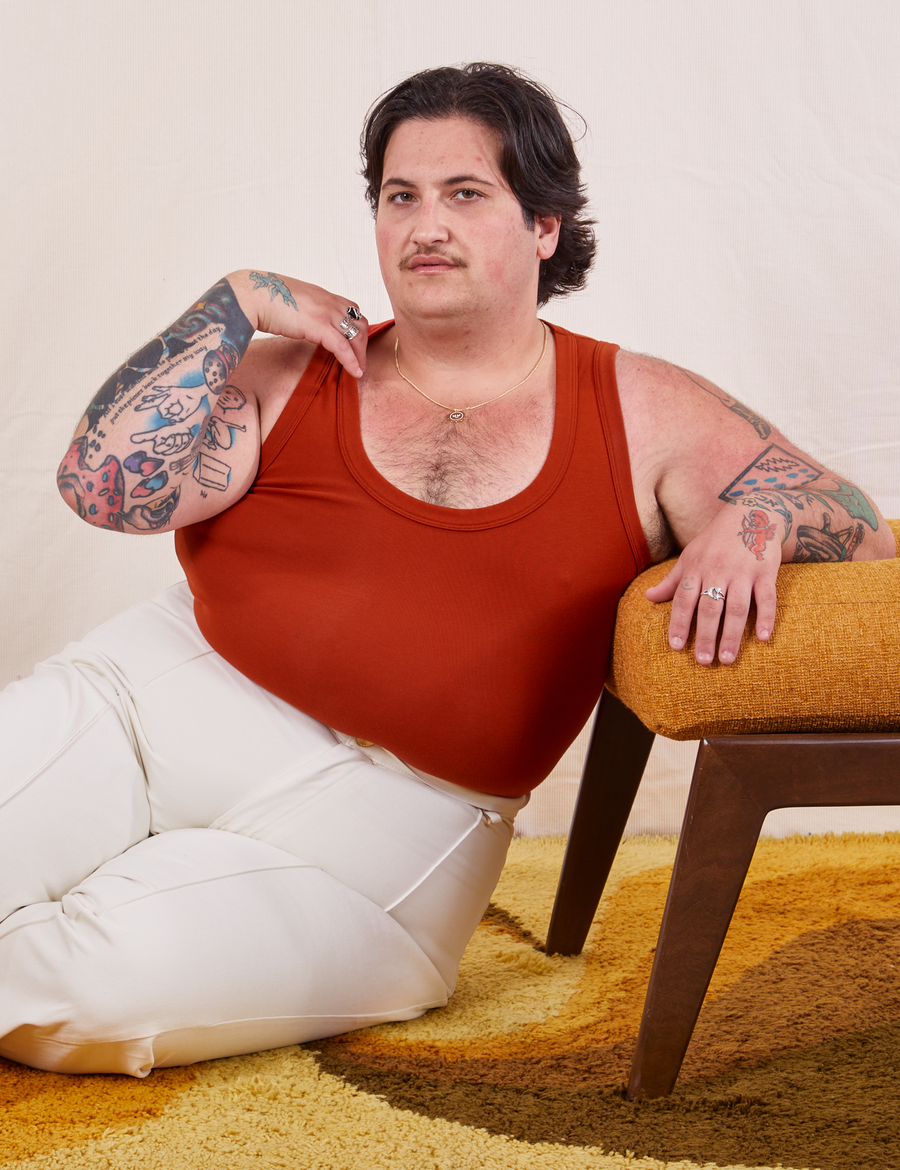 Sam is wearing size XL Tank Top in Paprika paired with vintage off-white Western Pants