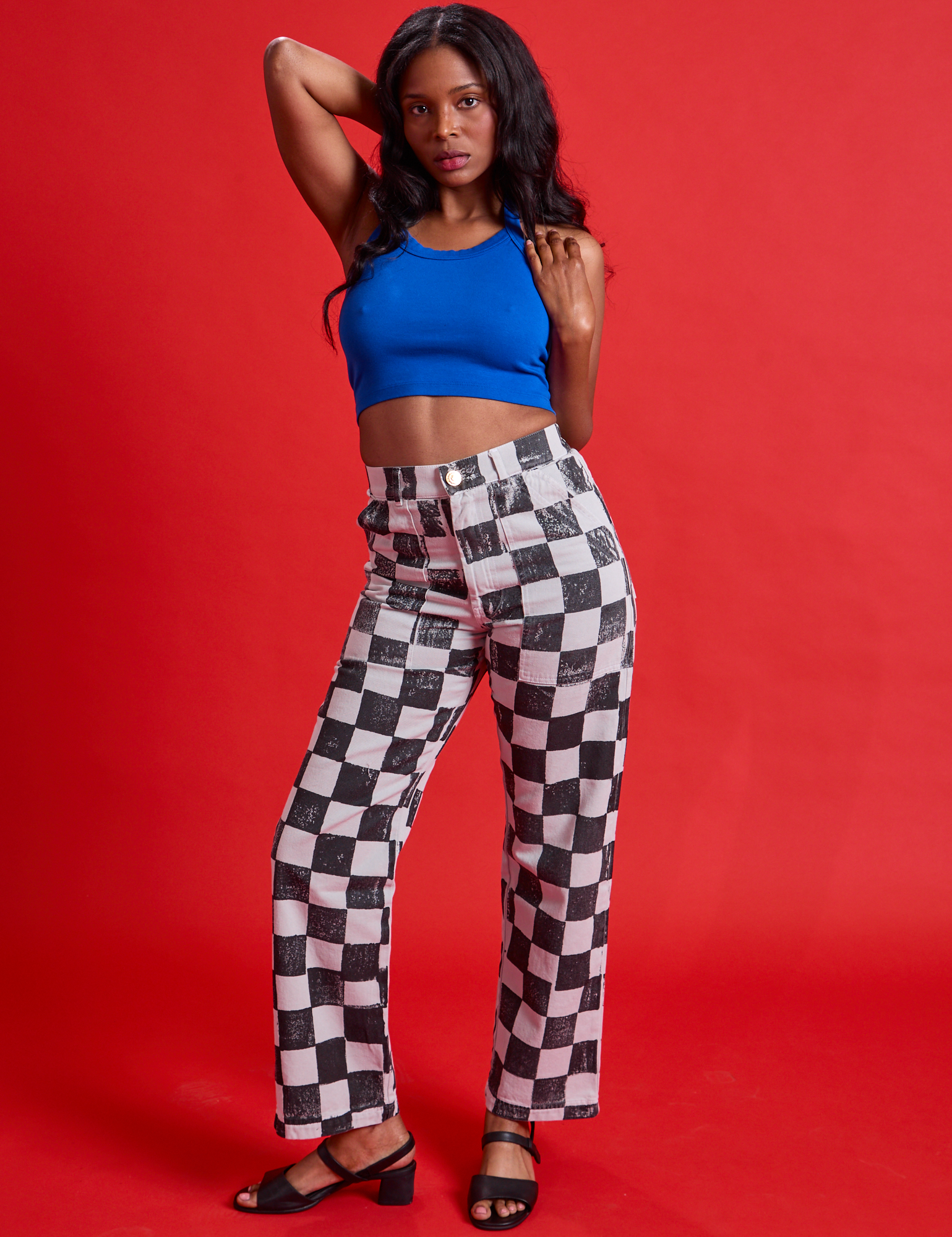 Kandia is 5'3" and wearing XS Checkerboard Work Pants in Black/White paired with royal blue Halter Top