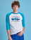 Quinn is 6'3" and wearing M Taxi Raglan Tee in San Francisco. White tee body with blue raglan sleeves.