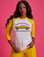 Kandia is 5'3" and wearing XS Taxi Raglan Tee in Toronto. White tee body with yellow raglan sleeves.