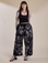 Sydney is 5'9" and wearing L for an oversized look Magic Waters Drop Pocket Pants in Ink Blot paired with black Cropped Tank