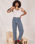 Jesse is 5'8" and wearing XXS Denim Trouser Jeans in Railroad Stripe paired with a vintage off-white Tank Top