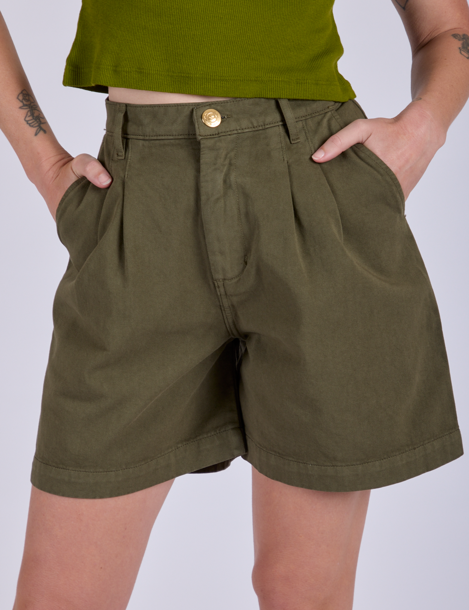Front close up of Pleated Trouser Shorts in Surplus Green on Alex