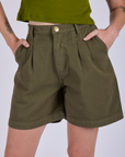 Front close up of Pleated Trouser Shorts in Surplus Green on Alex