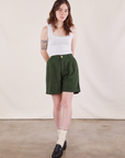 Hana is 5'3" and wearing XXS Trouser Shorts in Swamp Green paired with Cropped Tank Top in Vintage Tee Off-White