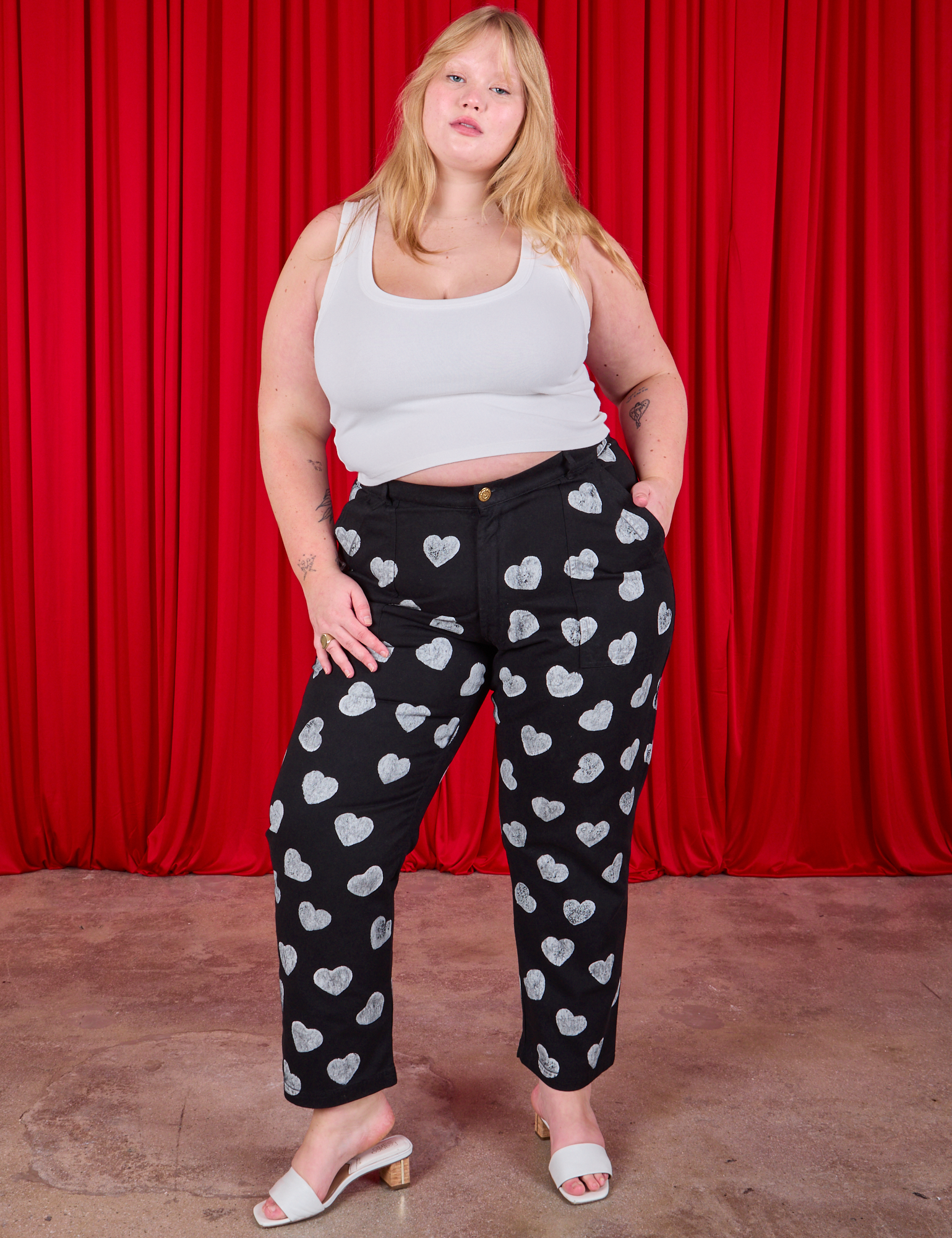 Juliet is 5&#39;7&quot; and wearing 1XL Paintstamped Heart Work Pants in Black paired with a Cropped Tank in vintage tee off-white