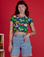 Alex is 5’8” and wearing P Veggie Village Cropped Baby Tee paired with light wash Denim Carpenter Shorts