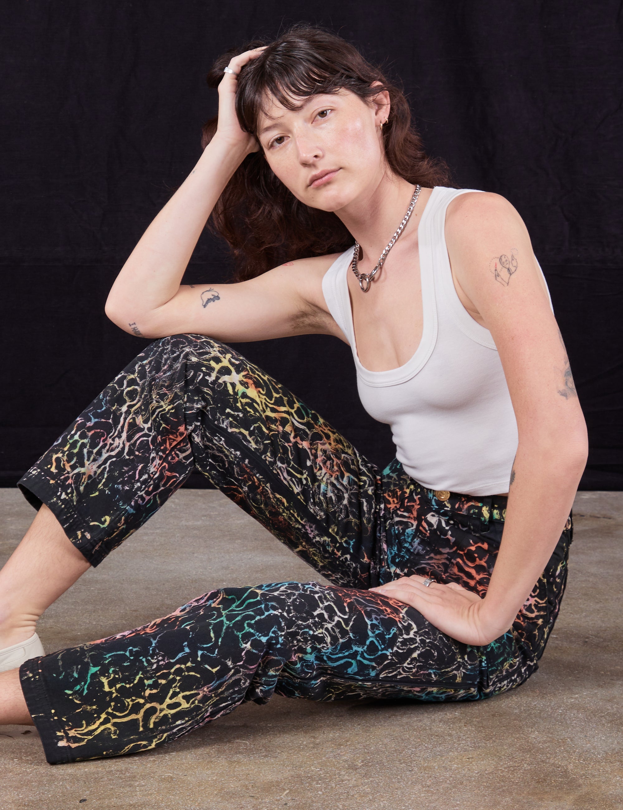 Alex is wearing Wavy Dye Work Pants paired with vintage off-white Cropped Tank Top