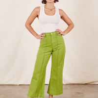 Soraya is 5'2" and wearing XXS Petite Western Pants in Gross Green paired with a vintage off-white Tank Top