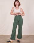 Alex is 5'8" and wearing XS Western Pants in Dark Green Emerald paired with a vintage off-white Tank Top