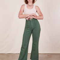 Alex is 5'8" and wearing XS Western Pants in Dark Green Emerald paired with a vintage off-white Tank Top