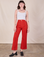 Alex is 5'8" and wearing XS Western Pants in Mustang Red paired with a Cami in Vintage Tee Off-White