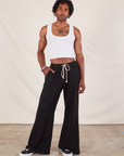 Jerrod is 6'3" and wearing S Wide Leg Sweat Pants in Basic Black paired with a Cropped Tank in vintage tee off-white