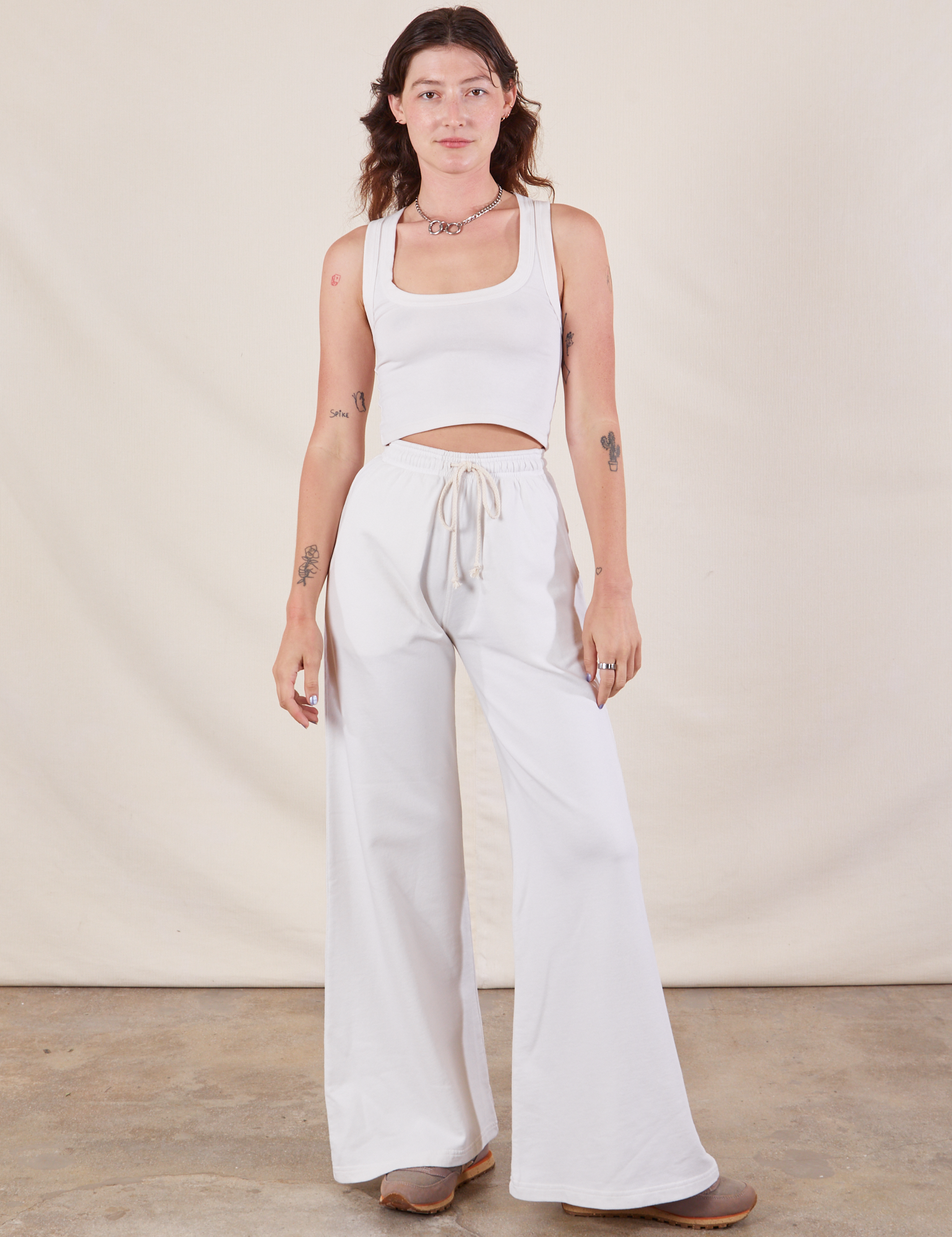 Alex is 5&#39;8&quot; and wearing P Wide Leg Sweat Pants in Vintage Tee Off-White paired with Cropped Tank