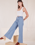 Alex is 5'8" and wearing XXS Indigo Wide Leg Trousers in Light Wash paired with Cropped Tank Top in Vintage Off-White