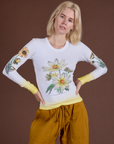 Madeline is 5’9” and wearing P Floral Long Sleeve Baby Tee in Yellow