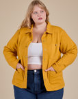 Juliet is 5'8" and wearing L Denim Work Jacket in Mustard Yellow