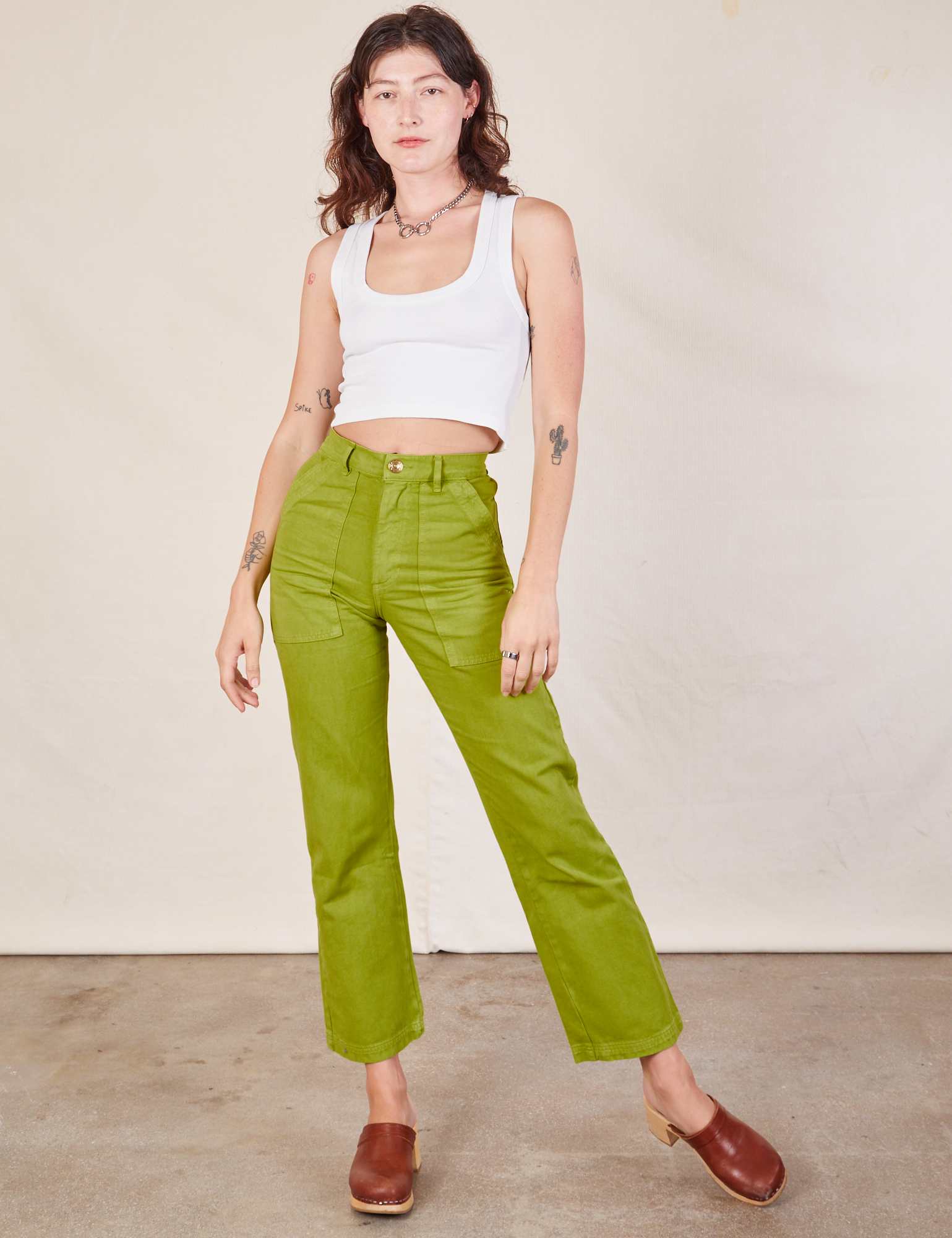 Alex is 5'8" and wearing XXS Work Pants in Gross Green paired with a Cropped Tank in vintage tee off-white