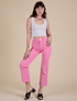 Alex is 5’8” and wearing XS Work Pants in Bubblegum Pink paired with a vintage tee white Cropped Tank