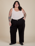 Sam is 5’10” and wearing 4XL Work Pants in Basic Black paired with a Tank Top in Vintage Tee Off-White
