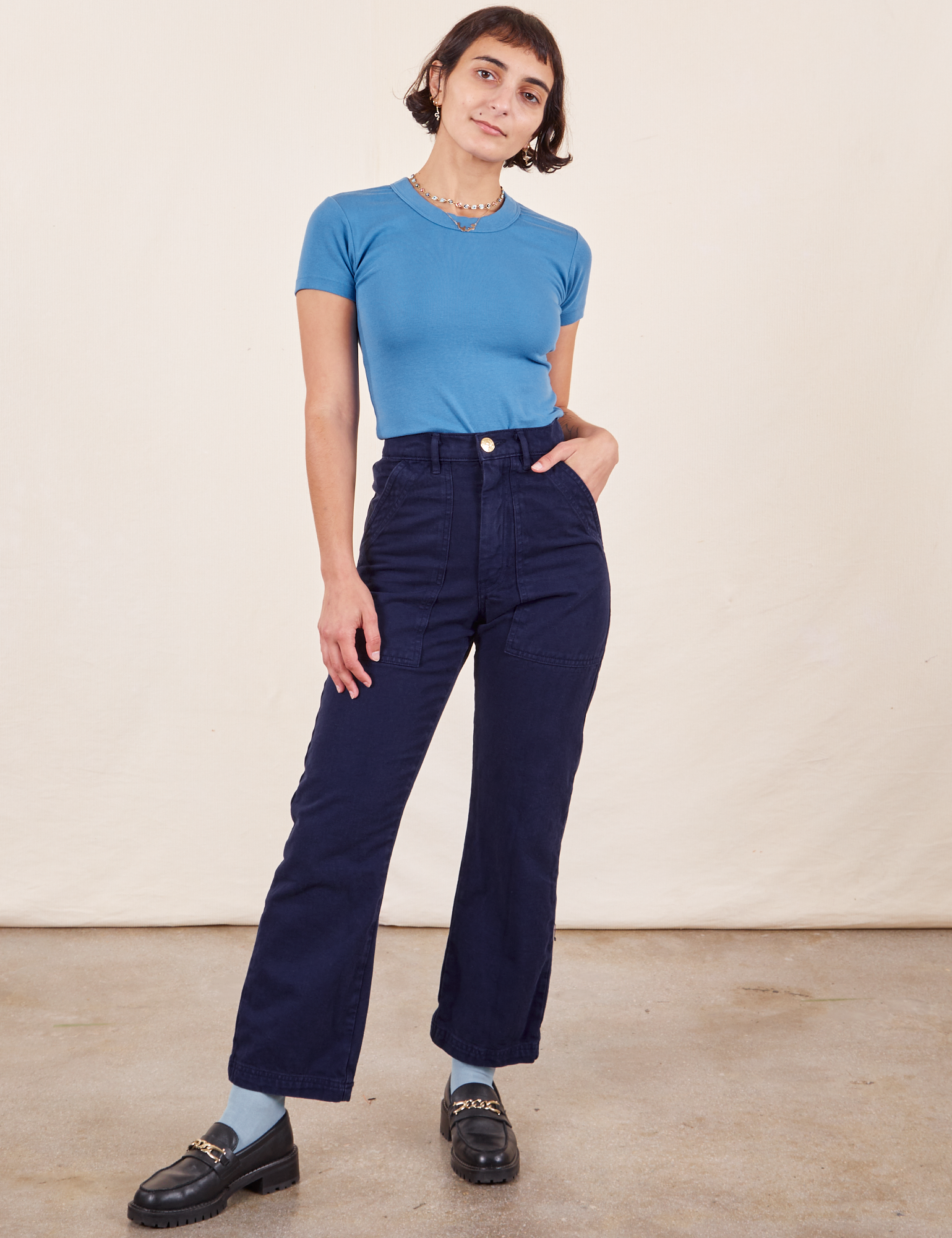 Soraya is 5&#39;2&quot; and wearing Petite XXS Work Pants in Navy Blue paired with Greek Blue Baby Tee
