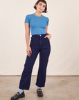 Soraya is 5'2" and wearing Petite XXS Work Pants in Navy Blue paired with Greek Blue Baby Tee