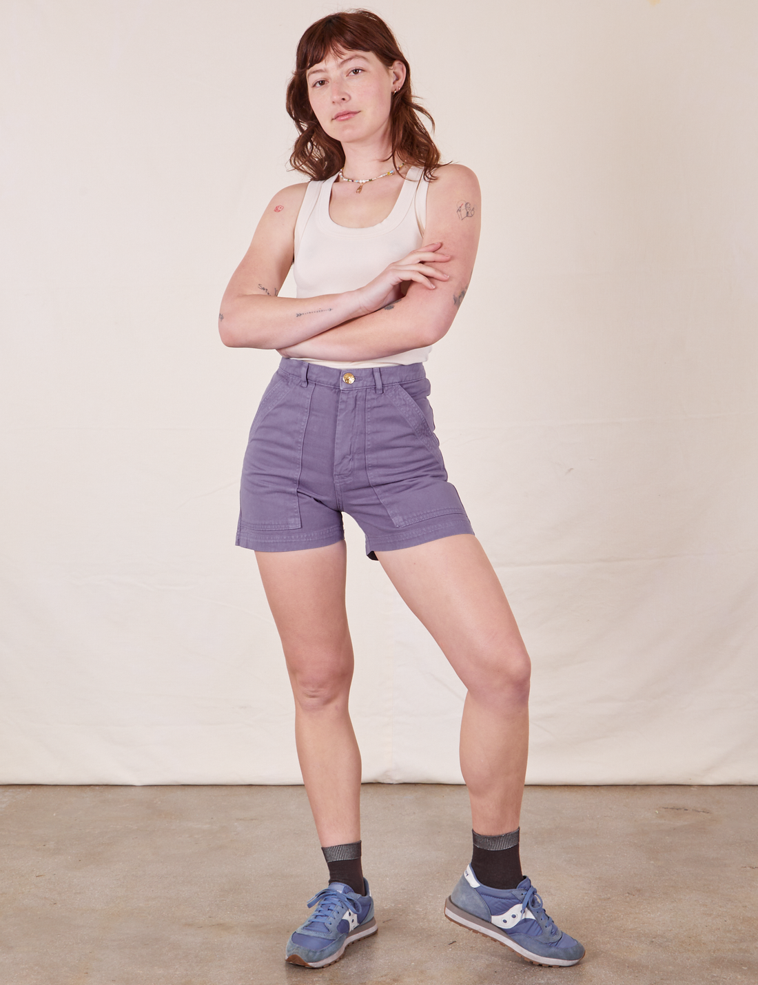 Alex is 5'8" and wearing size XS Classic Work Shorts in Faded Grape paired with a vintage off-white Tank Top