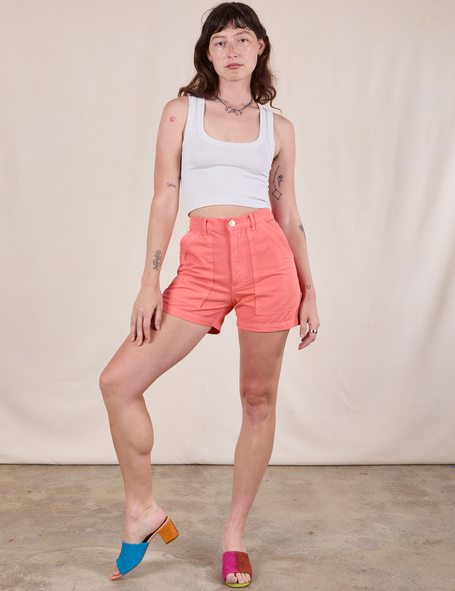 Alex is 5'8" and wearing XS Classic Work Shorts in Flamingo Pink paired with a Cropped Tank in vintage tee off-white