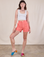 Alex is 5'8" and wearing XS Classic Work Shorts in Flamingo Pink paired with a Cropped Tank in vintage tee off-white