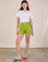 Alex is 5'8" and wearing XS Classic Work Shorts in Gross Green paired with a Burly Tee in Vintage Tee Off-White