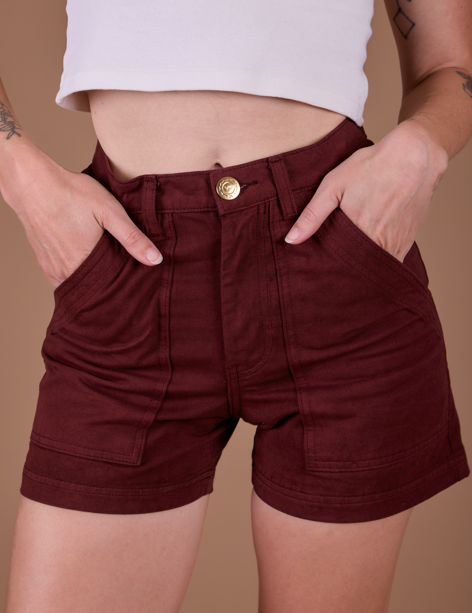 Close up of Alex's hands in the front pockets of Classic Work Shorts in Red Wine