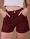 Close up of Alex's hands in the front pockets of Classic Work Shorts in Red Wine